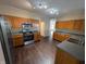 Functional kitchen with ample wooden cabinetry, stainless steel appliances, and dark countertops at 5565 Noble Dr, Indianapolis, IN 46234