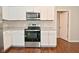 Kitchen features white cabinets, granite countertops, stainless steel appliances and a view into the dining area at 5565 Noble Dr, Indianapolis, IN 46234