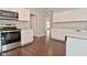 Well-lit kitchen boasts stainless steel appliances, granite countertops, and white cabinets at 5565 Noble Dr, Indianapolis, IN 46234