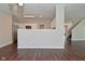 Open-concept living room showcases hardwood floors, leading to kitchen and staircase at 5565 Noble Dr, Indianapolis, IN 46234