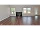 Cozy living room with a marble fireplace, large windows, and hardwood floors at 5565 Noble Dr, Indianapolis, IN 46234