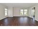 Open living room features wood-look flooring and natural light from the windows at 5565 Noble Dr, Indianapolis, IN 46234