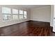 Spacious living room featuring hardwood floors, and multiple windows offering ample natural light at 5565 Noble Dr, Indianapolis, IN 46234