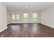 Spacious living room with large windows and dark wood-look flooring at 5565 Noble Dr, Indianapolis, IN 46234