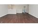 Open loft area with hardwood style floors and view to upstairs landing at 5565 Noble Dr, Indianapolis, IN 46234