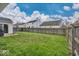 Expansive backyard with a lush green lawn, framed by a sturdy wooden fence at 714 Breakers Ln, Fortville, IN 46040