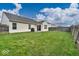 Spacious backyard featuring lush green lawn, patio with grill, perfect for outdoor entertaining at 714 Breakers Ln, Fortville, IN 46040