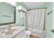 This bathroom features a shower and tub, a vanity with a sink and a large mirror at 714 Breakers Ln, Fortville, IN 46040