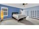 Spacious bedroom with neutral carpet, a ceiling fan, and bright windows for natural light at 714 Breakers Ln, Fortville, IN 46040