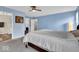 Comfortable bedroom with blue walls, ceiling fan, neutral carpet, and a large bed at 714 Breakers Ln, Fortville, IN 46040