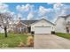 Charming single-Gathering home featuring a two-car garage, brick accents, and a well-maintained lawn at 714 Breakers Ln, Fortville, IN 46040