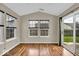 Bright sun room with hardwood floors and a sliding glass door leading to the backyard at 714 Breakers Ln, Fortville, IN 46040