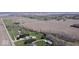 Drone footage over property showing house, outbuildings, driveway, and farmland beyond at 7180 N State Road 42, Eminence, IN 46125