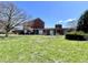 Large backyard with a brick house and a covered pergola at 7180 N State Road 42, Eminence, IN 46125