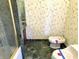 This bathroom features distinctive dark green marble tiling and bird-themed wallpaper at 7180 N State Road 42, Eminence, IN 46125