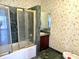Bathroom with a marble-enclosed shower, a sink, and unique bird-themed wallpaper at 7180 N State Road 42, Eminence, IN 46125