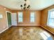 A bedroom featuring hardwood floors, a vintage chandelier and textured orange wallpaper at 7180 N State Road 42, Eminence, IN 46125