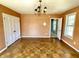 Bedroom featuring hardwood floors, orange textured wallpaper, an overhead light and a doorway at 7180 N State Road 42, Eminence, IN 46125
