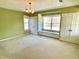 Bedroom with green walls, two closets, carpeted floors and a window seat between two windows at 7180 N State Road 42, Eminence, IN 46125