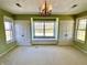 Spacious bedroom with a chandelier, window seat, and ample natural light at 7180 N State Road 42, Eminence, IN 46125