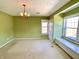 A light green bedroom with carpet, two windows with a window seat, an overhead light and a closet at 7180 N State Road 42, Eminence, IN 46125