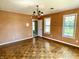 Bedroom featuring hardwood floors, overhead lighting, orange textured wallpaper and several large windows at 7180 N State Road 42, Eminence, IN 46125