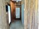 Hallway with wood paneled walls, tile flooring and exterior access at 7180 N State Road 42, Eminence, IN 46125