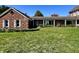 Spacious backyard with manicured lawn and blooming white flowers at 7180 N State Road 42, Eminence, IN 46125
