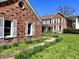 Charming brick home with white shutters and beautiful landscaping at 7180 N State Road 42, Eminence, IN 46125