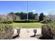 Landscaped front yard featuring manicured bushes and concrete vases at 7180 N State Road 42, Eminence, IN 46125