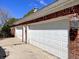Three-car garage with brick accents and white doors at 7180 N State Road 42, Eminence, IN 46125