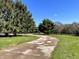 Scenic property featuring a winding driveway through mature trees and a lush lawn at 7180 N State Road 42, Eminence, IN 46125
