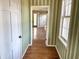 Hallway with hardwood floors, neutral paint, and windows offering natural light at 7180 N State Road 42, Eminence, IN 46125