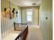Hallway view with striped wallpaper, white trim, overhead light fixture, window at the end of the hall at 7180 N State Road 42, Eminence, IN 46125