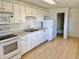 Well-lit kitchen with white appliances and cabinets, offering a practical cooking space at 7180 N State Road 42, Eminence, IN 46125