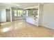 Open-concept living space adjoining a kitchen, featuring light-colored hardwood floors for a seamless feel at 7180 N State Road 42, Eminence, IN 46125