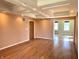 Living room featuring hardwood floors, built-in storage and coffered ceiling at 7180 N State Road 42, Eminence, IN 46125