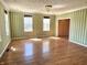 Bright living room with hardwood floors, classic chandelier, and large windows for natural light at 7180 N State Road 42, Eminence, IN 46125