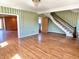 Living room features hardwood floors, staircase and opens to the kitchen, perfect for gatherings at 7180 N State Road 42, Eminence, IN 46125
