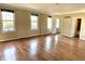 Spacious living room with hardwood floors, neutral paint, and natural light from many windows at 7180 N State Road 42, Eminence, IN 46125