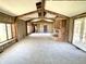 Spacious living room with exposed beams, a brick fireplace, and abundant natural light at 7180 N State Road 42, Eminence, IN 46125