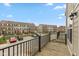 Balcony view of community, parking area, and neighboring townhomes on a sunny day at 7247 Barker St, Carmel, IN 46033