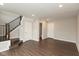 Spacious basement area with vinyl floors, a staircase, and multiple doors, offering flexible living at 7247 Barker St, Carmel, IN 46033