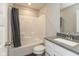 This bathroom features a shower-tub combo, granite countertop, and white vanity at 7247 Barker St, Carmel, IN 46033