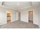 Bright bedroom with plush carpeting, and doorways to ensuite bathroom and walk-in closet at 7247 Barker St, Carmel, IN 46033