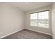 This bedroom has neutral walls, large window and soft carpeting at 7247 Barker St, Carmel, IN 46033