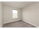 This bedroom has neutral walls, large window and soft carpeting at 7247 Barker St, Carmel, IN 46033