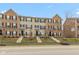 Charming townhomes featuring brick and vinyl exteriors, complemented by manicured lawns and inviting front entrances at 7247 Barker St, Carmel, IN 46033