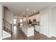 Open kitchen with white cabinets, a kitchen island, stainless steel appliances, and modern finishes at 7247 Barker St, Carmel, IN 46033
