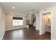 Bright living room with vinyl floors, large windows, and an adjacent half bathroom, providing a comfortable space at 7247 Barker St, Carmel, IN 46033
